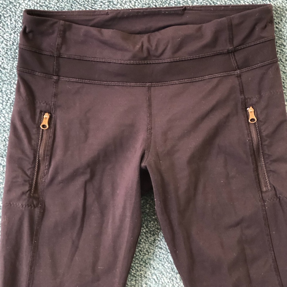 Lululemon leggings with gold zipper pockets and mesh ankle detail